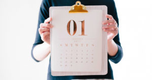 woman holds calendar for January