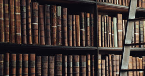 library shelf with old brown books