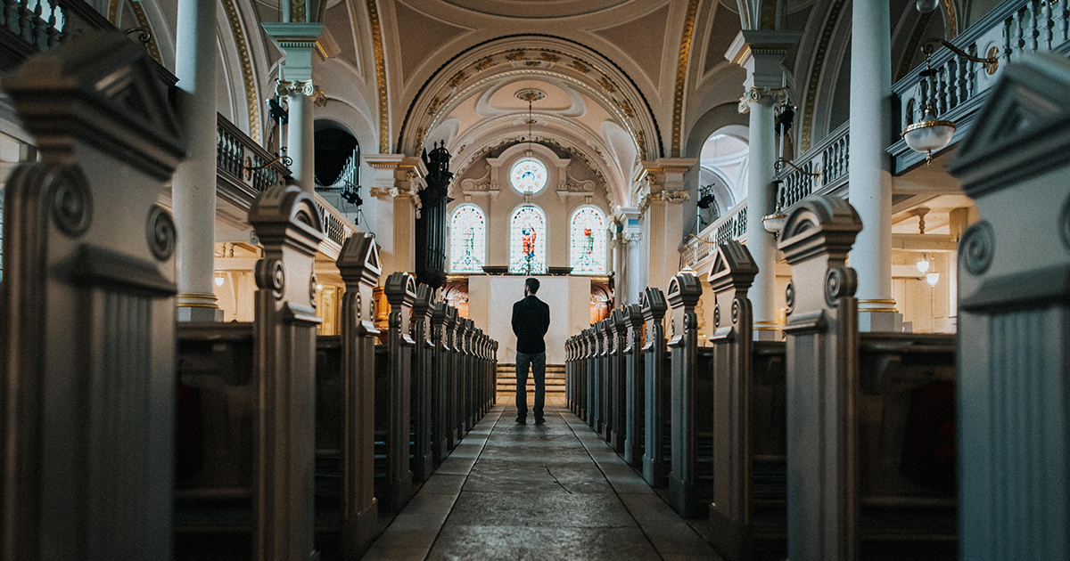 man standing near the alter in a Church