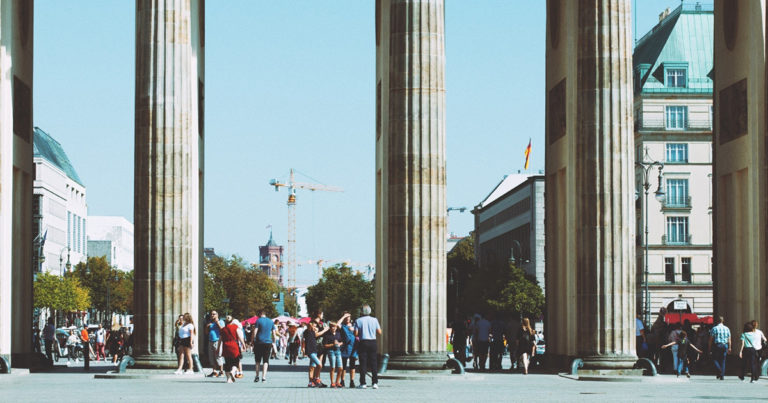 people standing near three large pillars